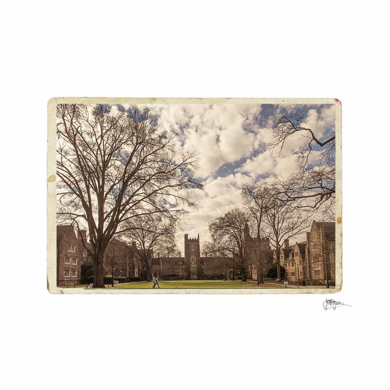 Vintage-style image of a university courtyard featuring Gothic architecture. A walkway crosses the green space, with leafless trees framing the scene. A person walks along the path under a partly cloudy sky, giving a timeless and serene atmosphere.