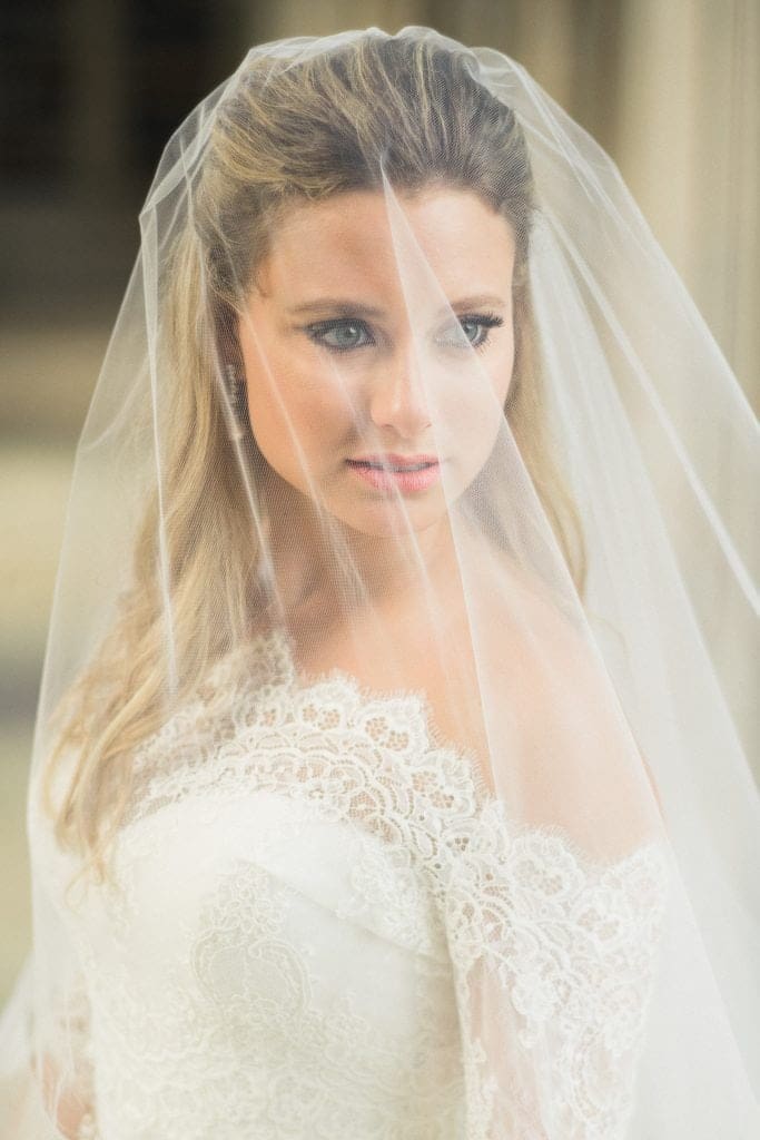 A captivating fine art bridal portrait from Sara's session, highlighting the delicate details of her veil and wedding dress against the historic Duke University Chapel architecture.