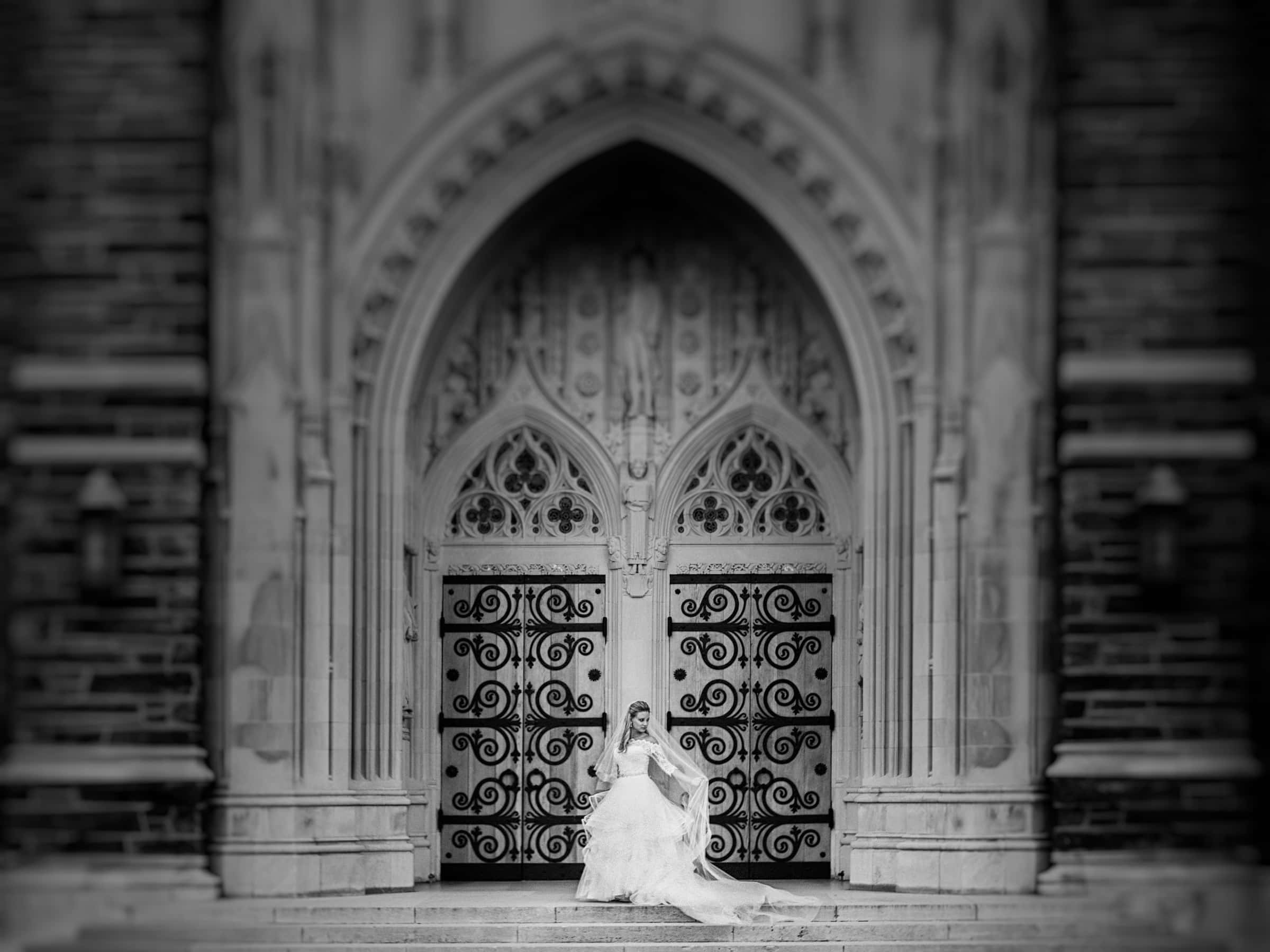 Duke Chapel Weddings A classical bridal session portrait of Sara showcasing the elegant details of her wedding dress against the historic backdrop of Duke University Chapel.