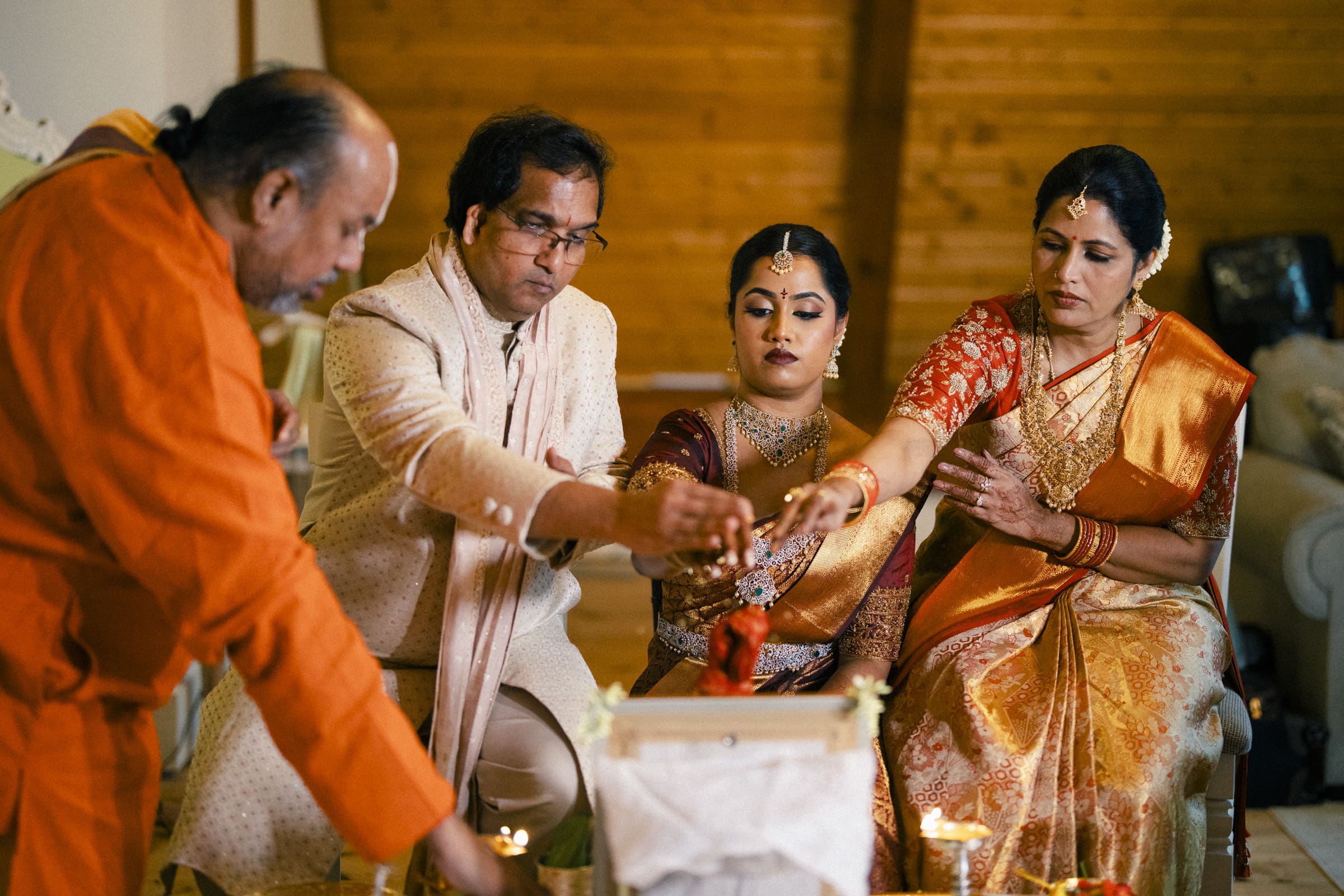 A traditional Hindu wedding ceremony with family gathered around the sacred fire at The Pavilion at Carriage Farm, captured by Joe Payne Photography.