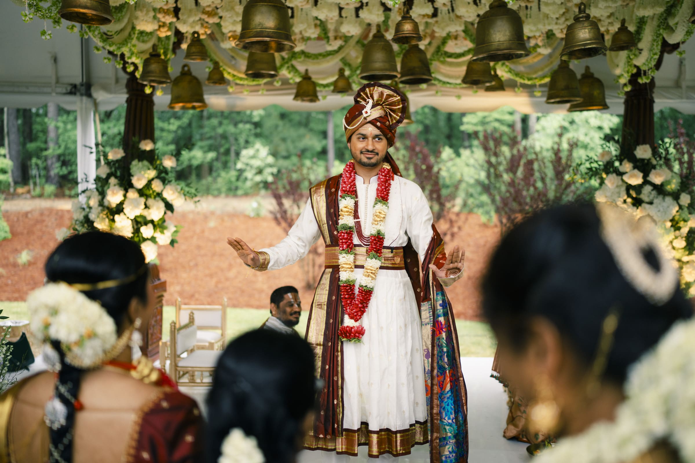 A bride and groom playfully perform the Jeelakarra Bellam ritual during their South Indian wedding ceremony at The Pavilion at Carriage Farm.